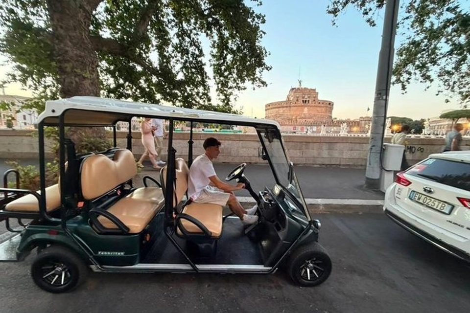 Our golf cart on the Tiber embankment with Castel Sant'Angelo behind