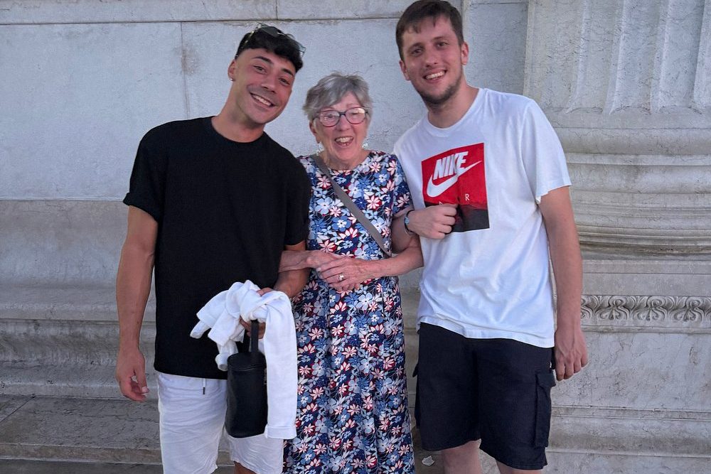 A guest with our drivers at the end of her golf cart tour of Rome