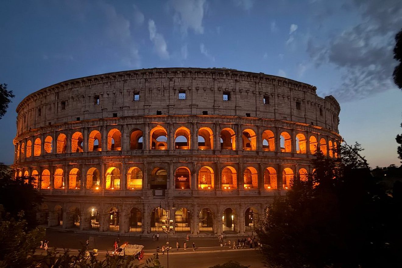 The Colosseum lit up at dusk, seen on our evening golf cart tour
