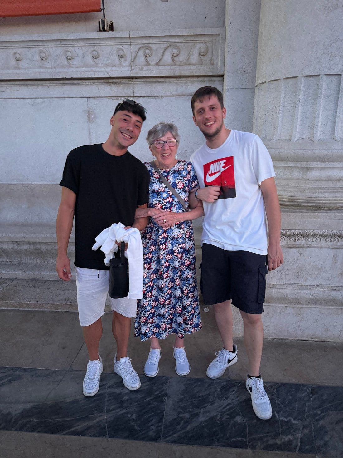 Two guides posing with an elderly guest outside Castel Sant’Angelo